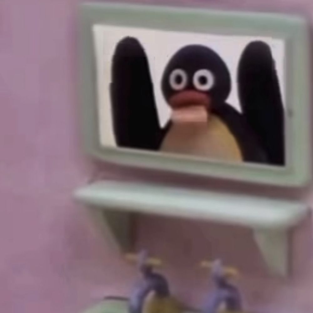 Cartoon penguin Pingu with raised flippers on a pink screen above a sink